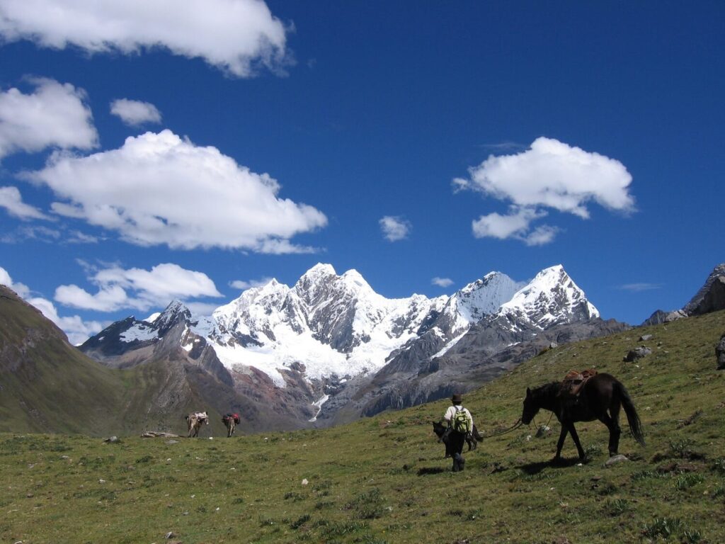 Spectacular mountain range with a horseman. Huayhuash, Peru. - RESPONSible Travel Peru