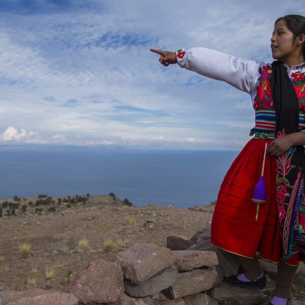local guide points out over Lake Titicaca from Amantani Island