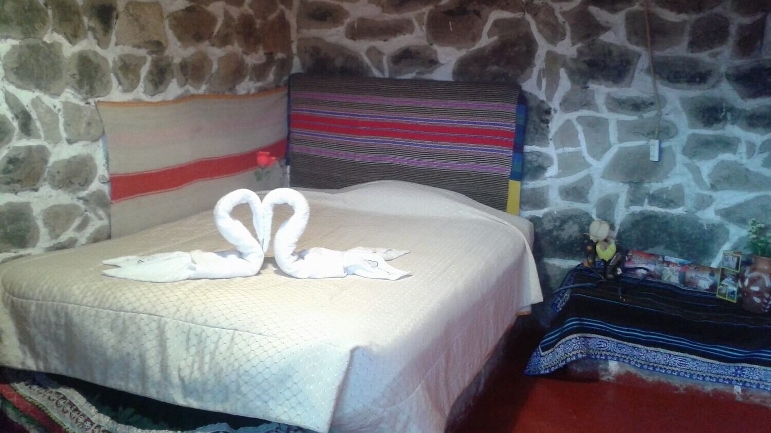 Decorated bed in homestay in Coporaque, Colca Canyon. Community-Based Tourism in Peru with RESPONSible Travel Peru.