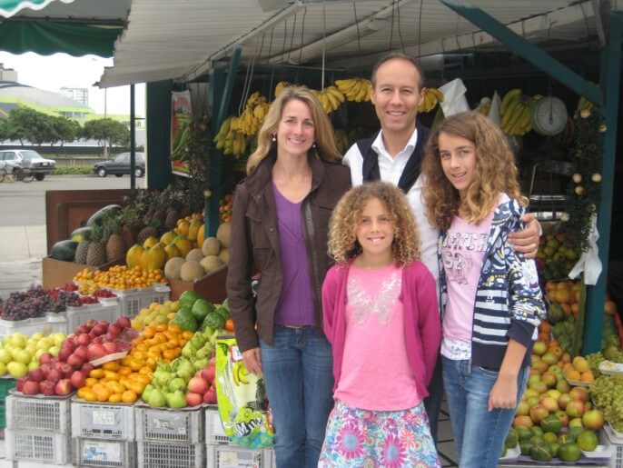11Family with two school-aged daughters at a market in Lima. Family-friendly trips from Responsible Travel Peru