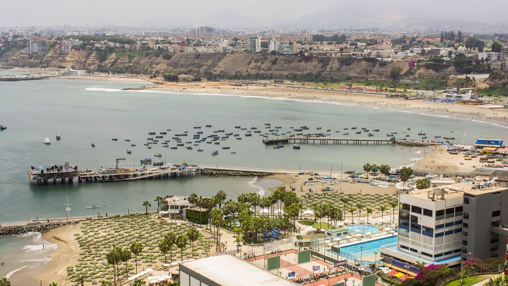 View of the beautiful bay of Barrancos and Chorrillos where you can see fishermen's boats and the artisanal dock | Responsible Travel Peru