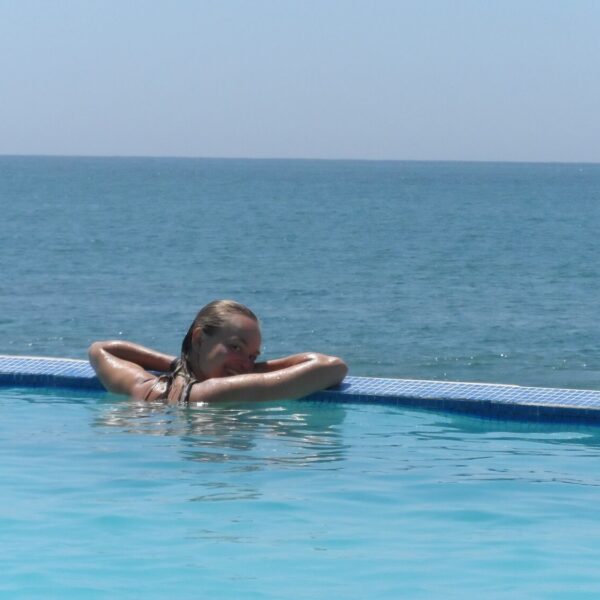 Agnes enjoying the view from a hotel pool at the beach of Máncora - RESPONSible Travel Peru