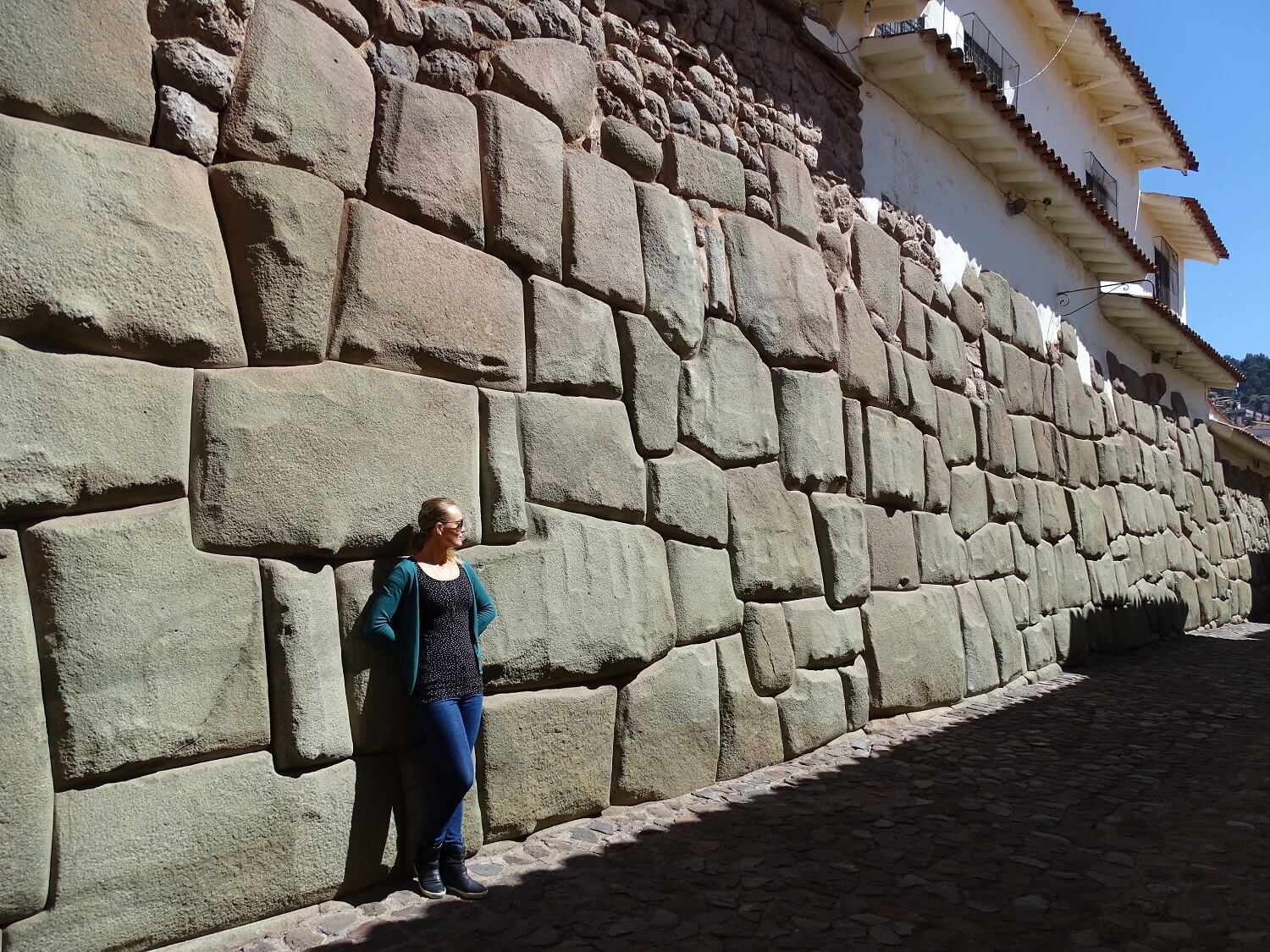 11Agnes standing at a beautiful Inca wall in Cusco, Peru | RESPONSible Travel Peru