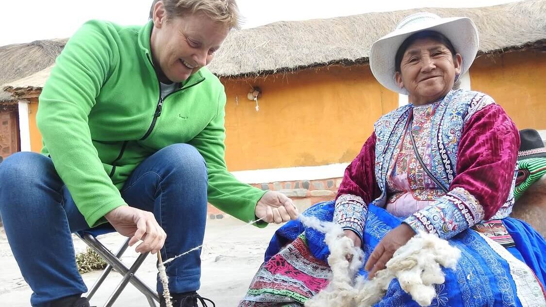 Traveler and local woman from Sibayo, Colca Canyon, sharing knowledge about wool spinning | RESPONSible Travel Peru