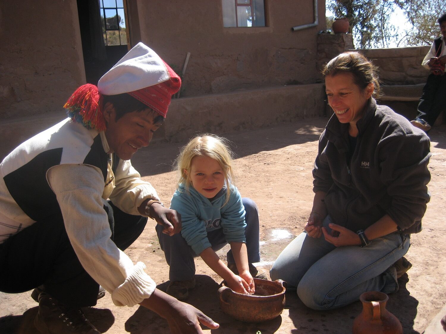11Traveling mom and daughter enjoying a cultural activity at a homestay experience on Taquile island, Lake Titicaca, Peru | RESPONSible Travel Peru