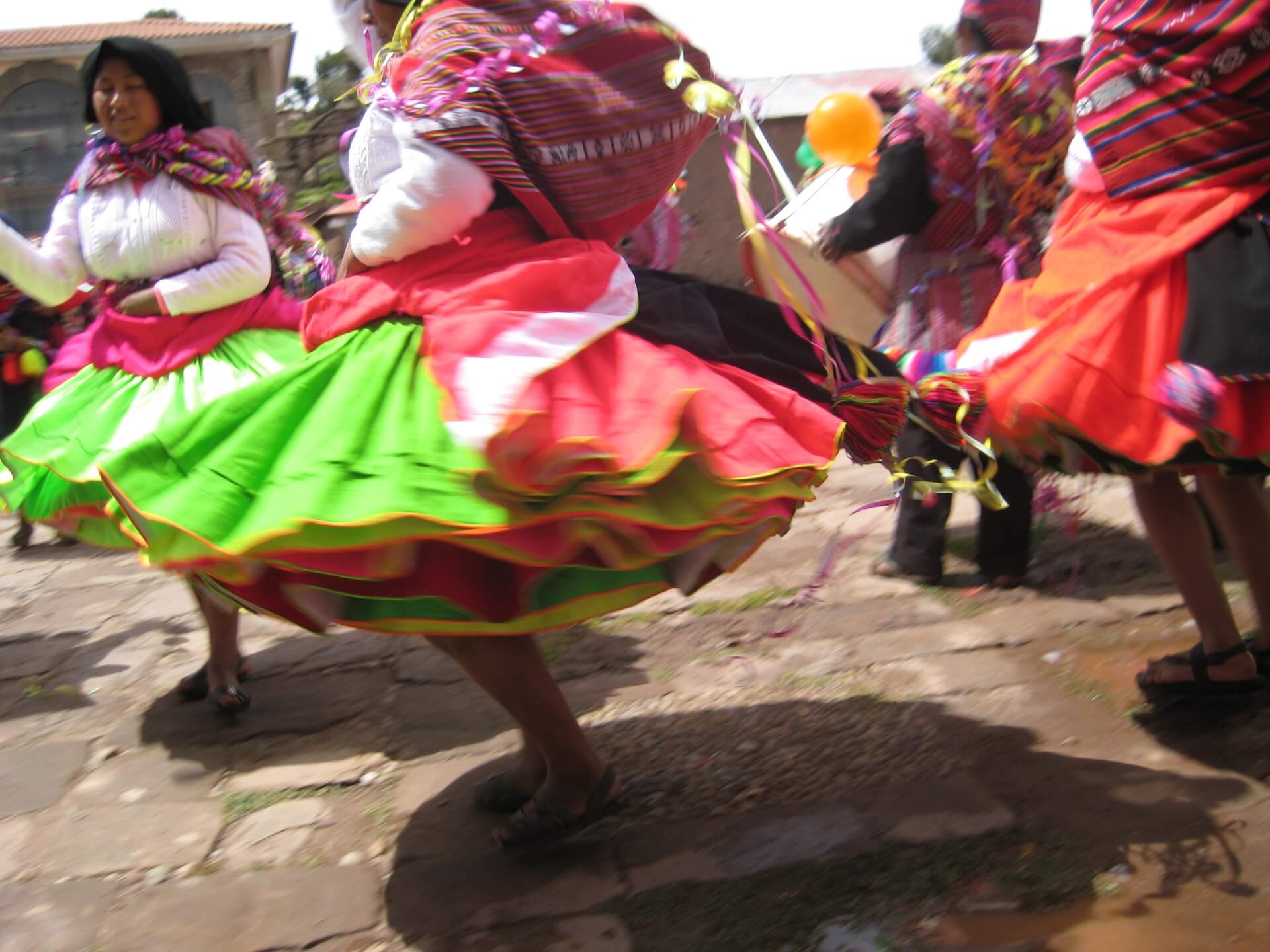 11Colorful traditional dresses worn by dancing women at a traditional fiesta on Taquile island, Lake Titicaca, Peru. | RESPONSible Travel Peru