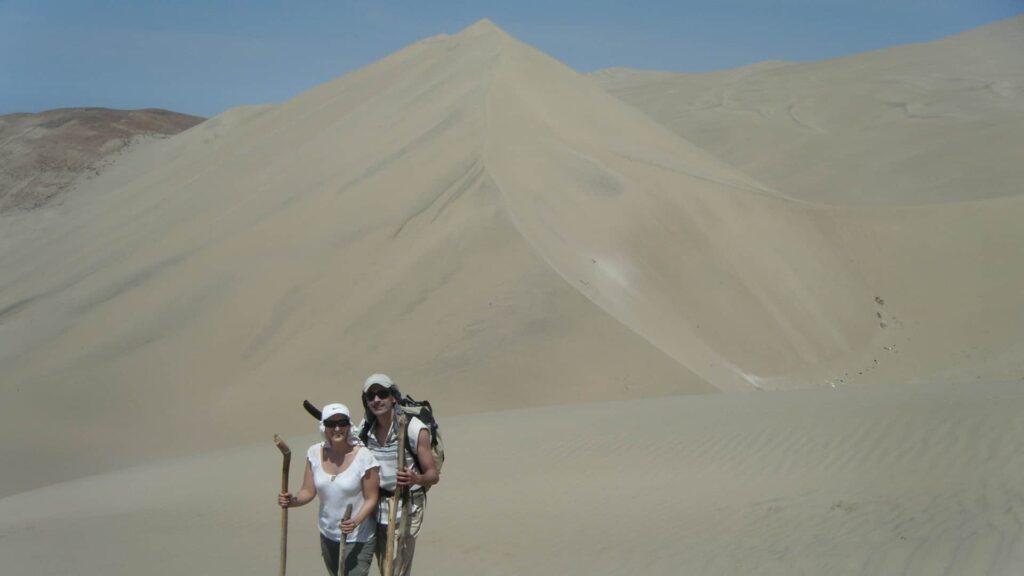 Couple walking through the Nazca desert to Cerro Blanco | RESPONSible Travel Peru