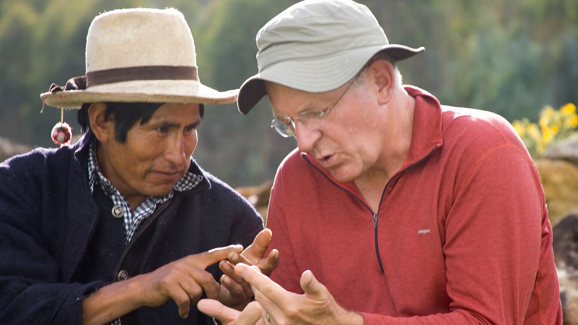 Two men practicing counting in their languages, Quechua and English, in Vicos Peru. Community-Based Tourism in Peru with RESPONSible Travel Peru