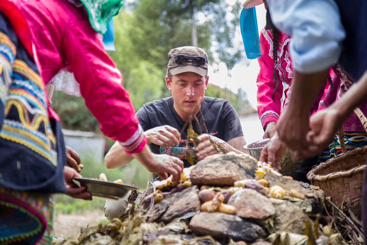 11Guido assisting the locals in Vicos with opening the Pachamanca and gathering the freshly cooked potatoes. Community-Based Tourism in the Andes - RESPONSible Travel Peru