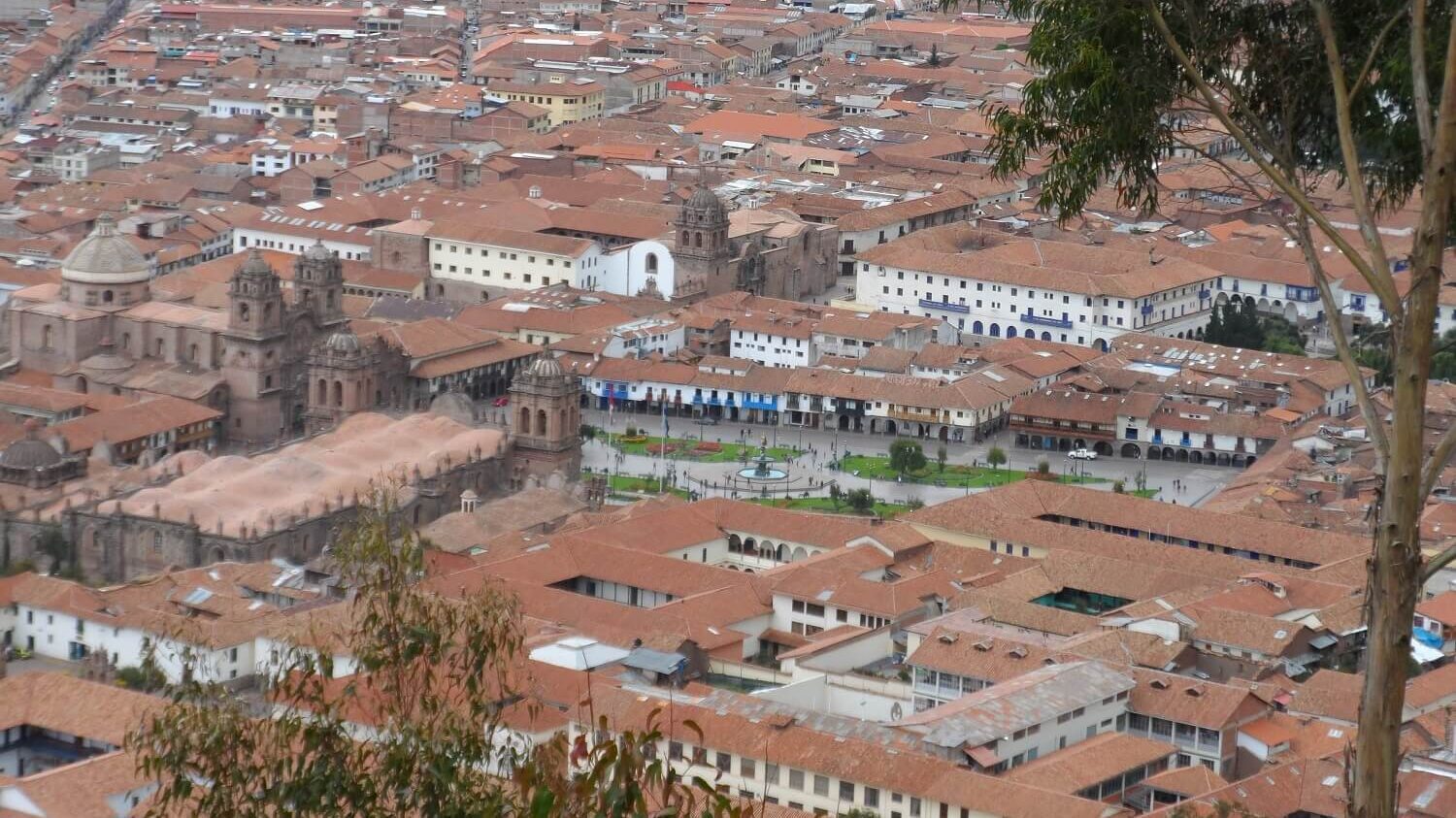 View to the historic center of Cusco, with the Plaza de Armas, churches and tiled rooftops. Visit Cusco alternatively with RESPONSible Travel Peru!