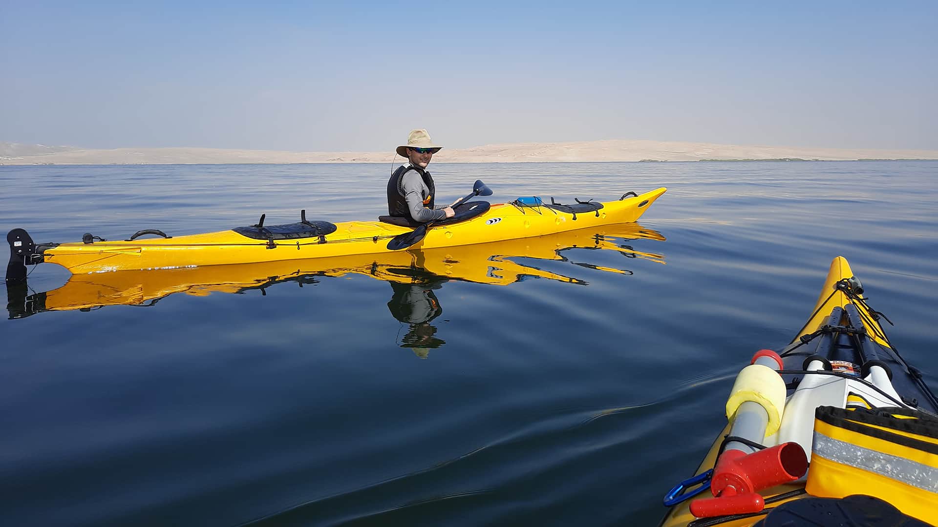 Single person kayaks over deep blue waters | Responsible Travel Peru