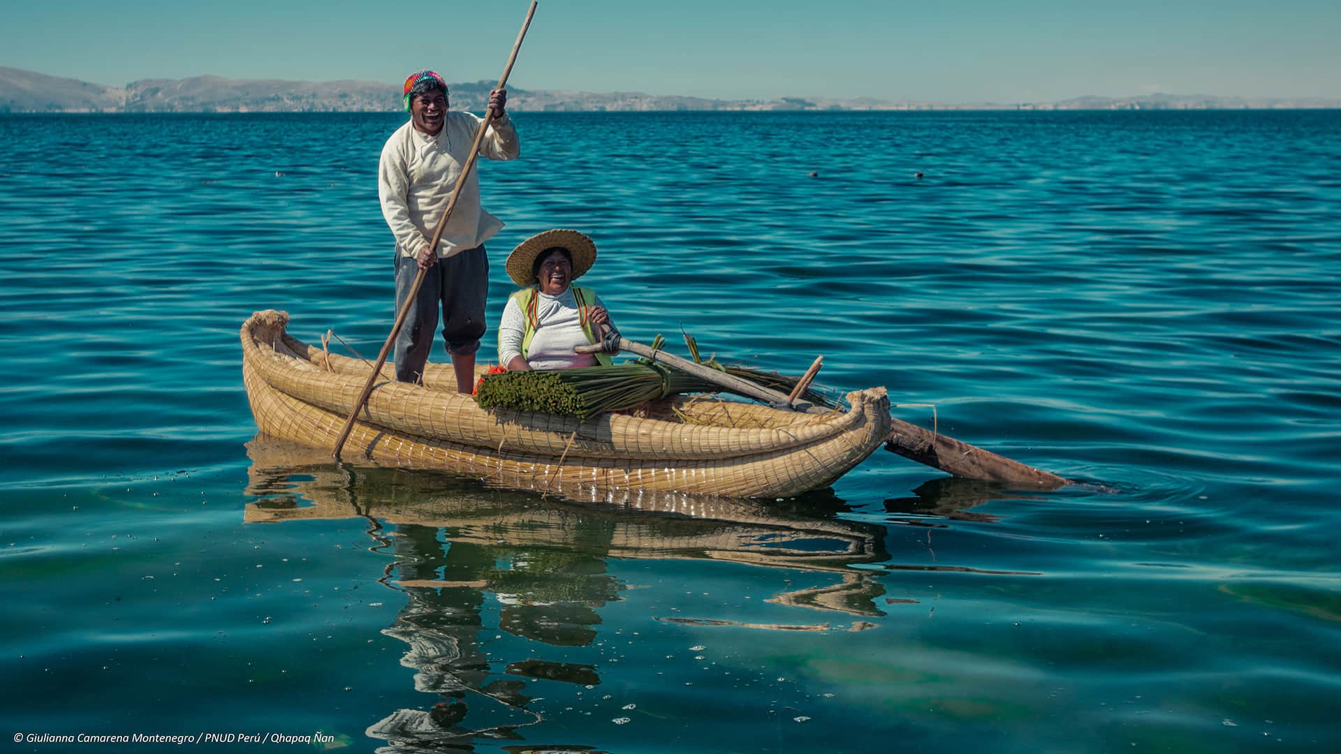 11Man (paddeling) and woman (sitting) on a reed boat while navigating over the water | Responsible Travel Peru
