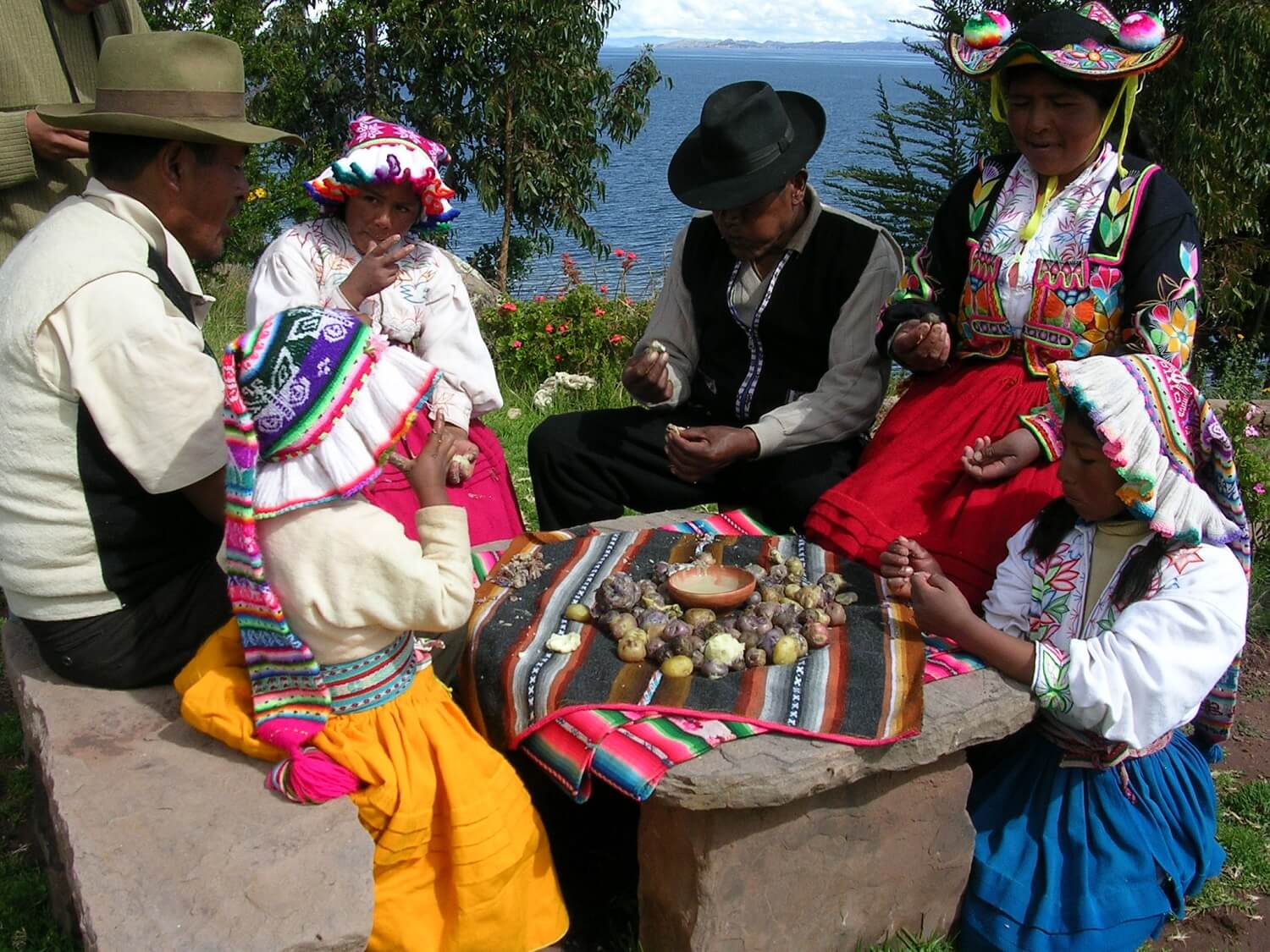 11Local inhabitants of Llachón wearing typical clothes enjoying a potatoe lunch. Community-Based tourism in Puno with RESPONSible Travel Peru