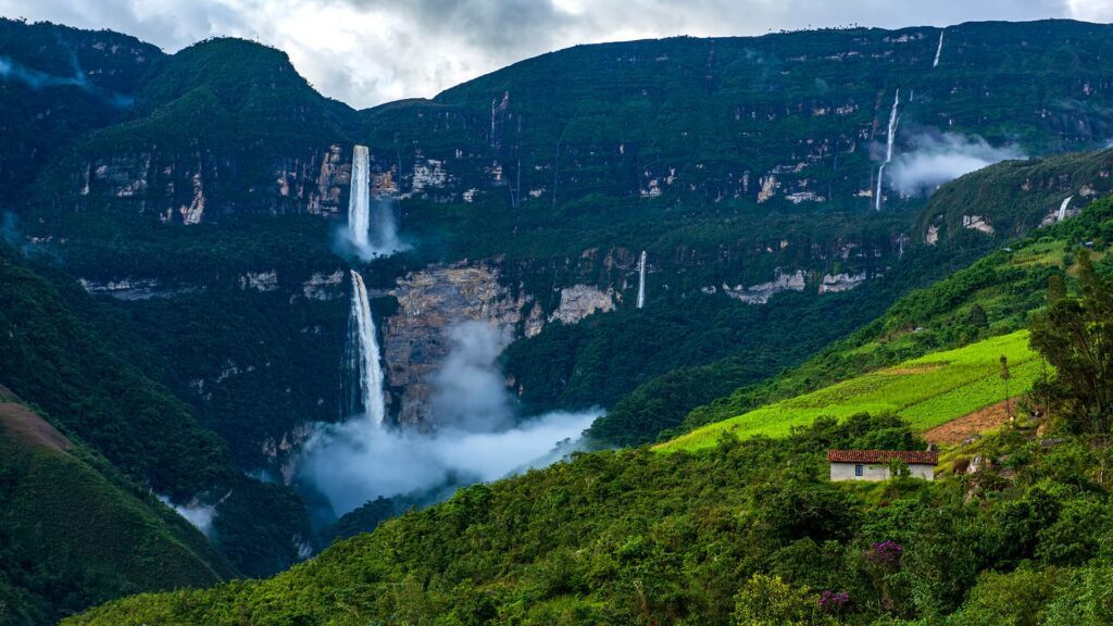 Panoramic view of Gocta waterfall of 770 meters high in a contrasting dark blue background of the mountains with the bright green of the forest | Responsible Travel Peru