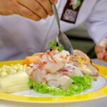 Close up of a chef serving ceviche on a dish | Responsible Travel Peru