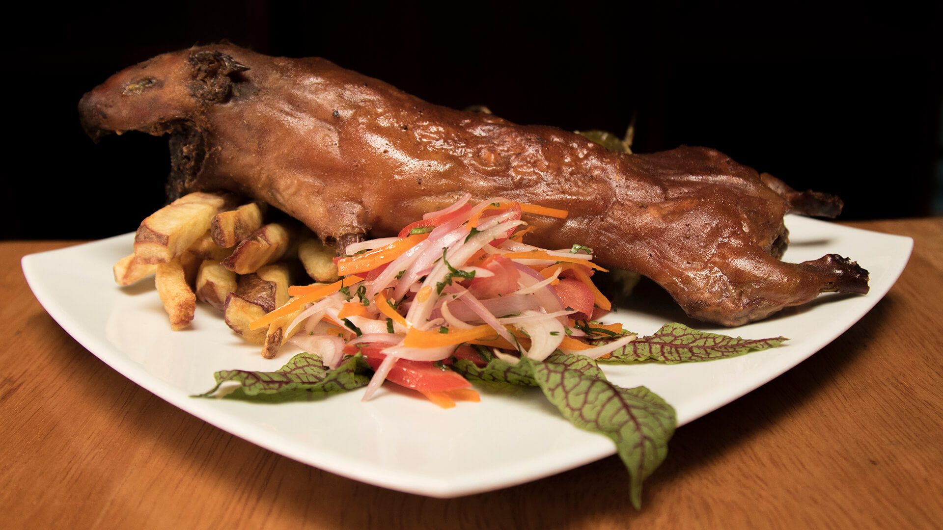 Guinea pig is a famous dish in Peru, here with fries and creole salad | RESPONSible Travel Peru