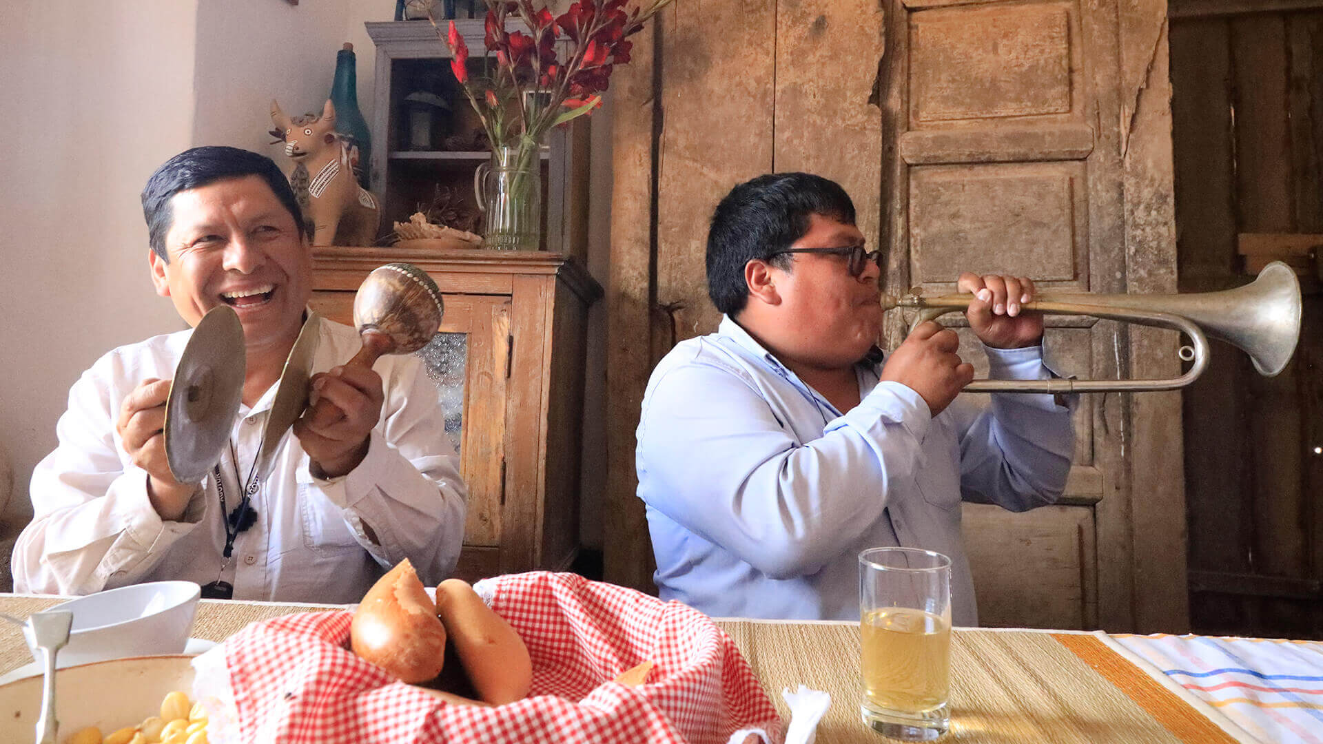 Peruvian tourist guide and his driver are cheerfully participating in a Peruvian music workshop | RESPONSible Travel Peru