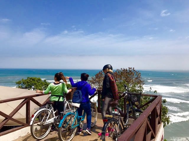 Passengers riding a bike around Barranco - Lima