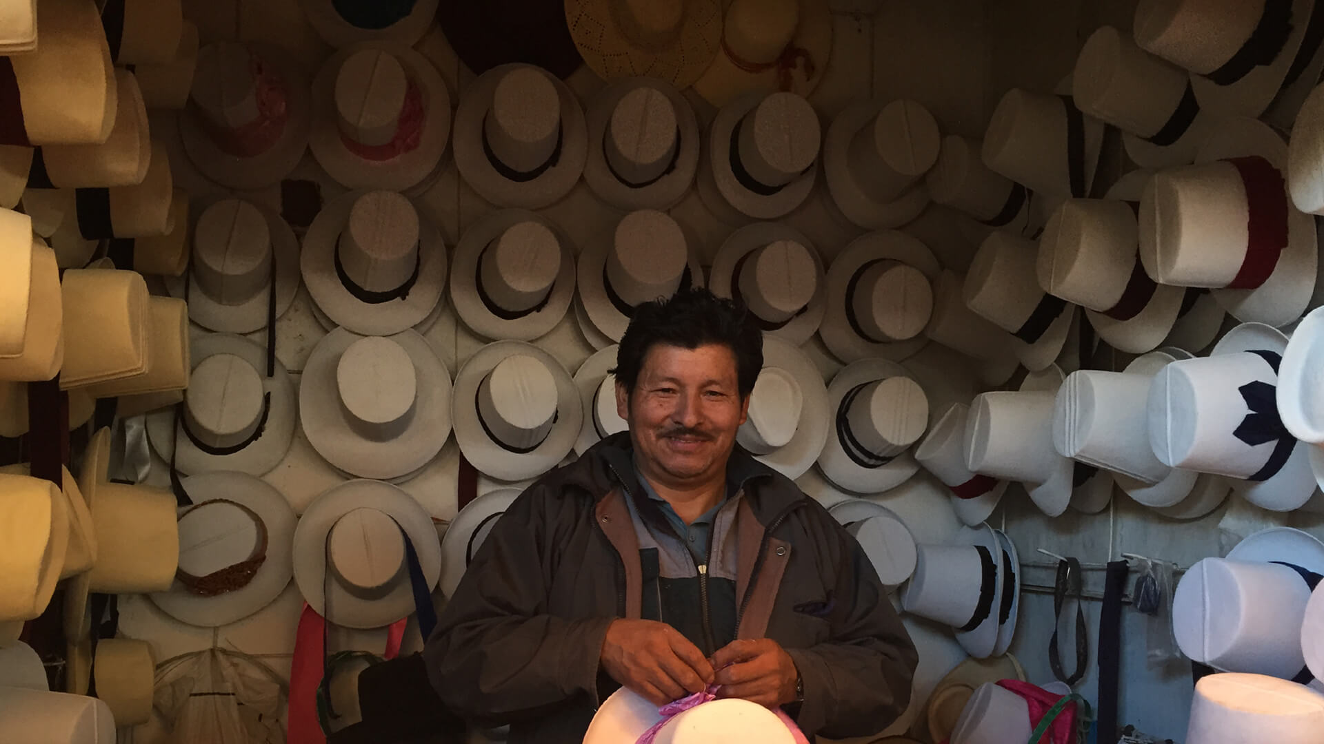 Smiling hat maker at market stall in Cusco | RESPONSible Travel Peru