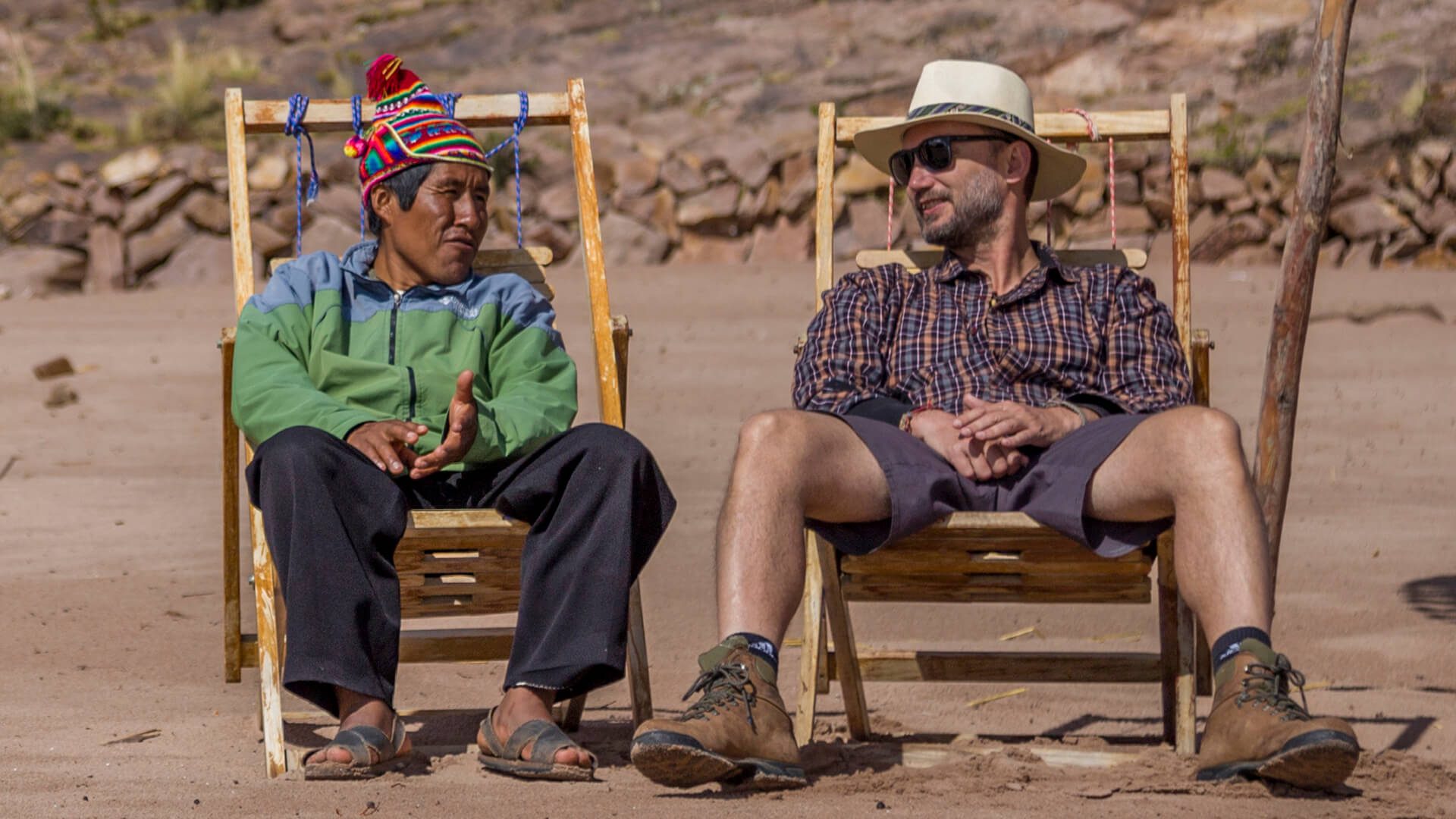 Celso and Alex talking while taking the sun at the beach in Taquile island, Titicaca - RESPONSible Travel Peru