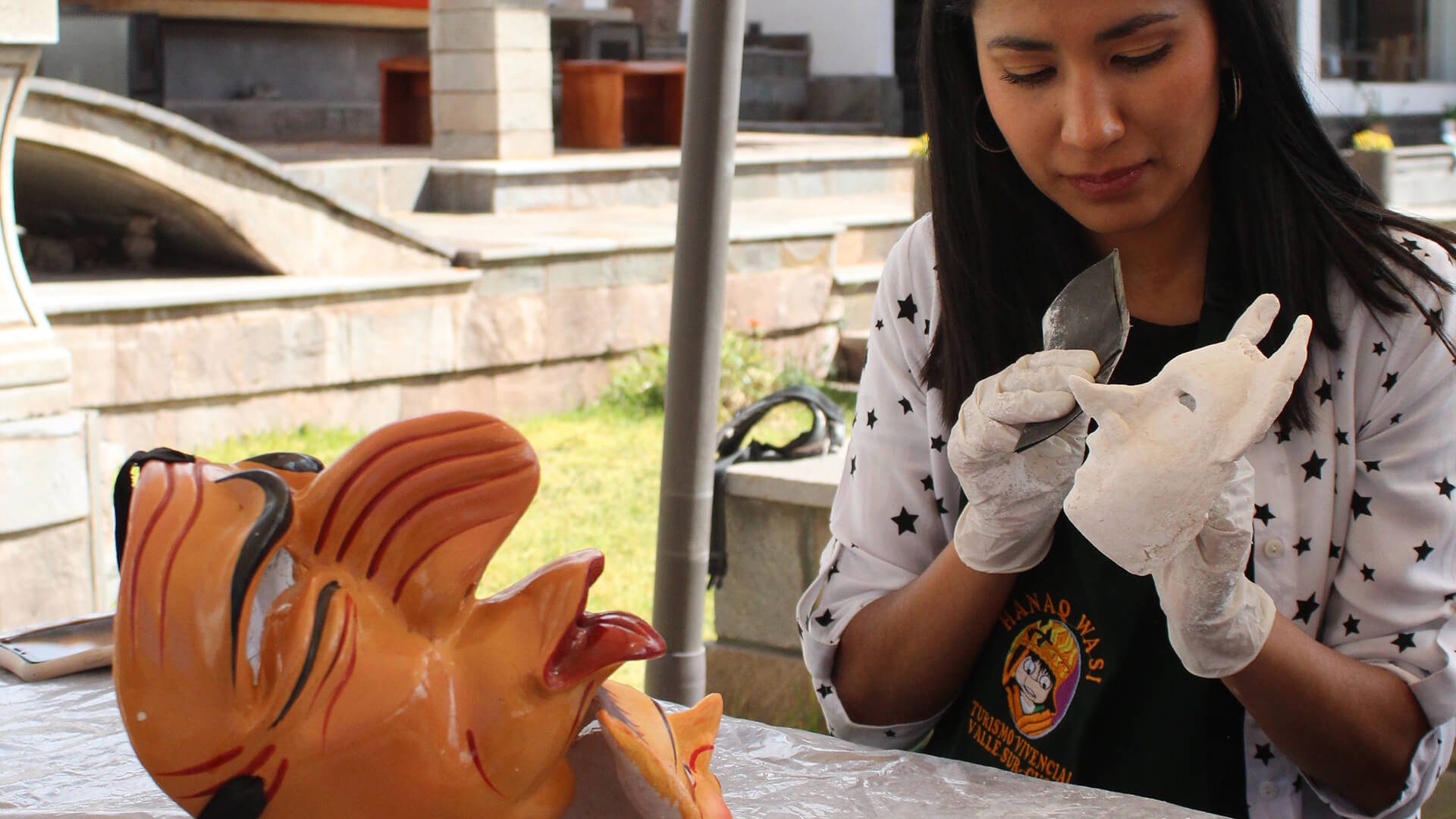 Young woman participating on the masks workshop taking place ar Hanaq Wasi's garden - RESPONSible Travel Peru