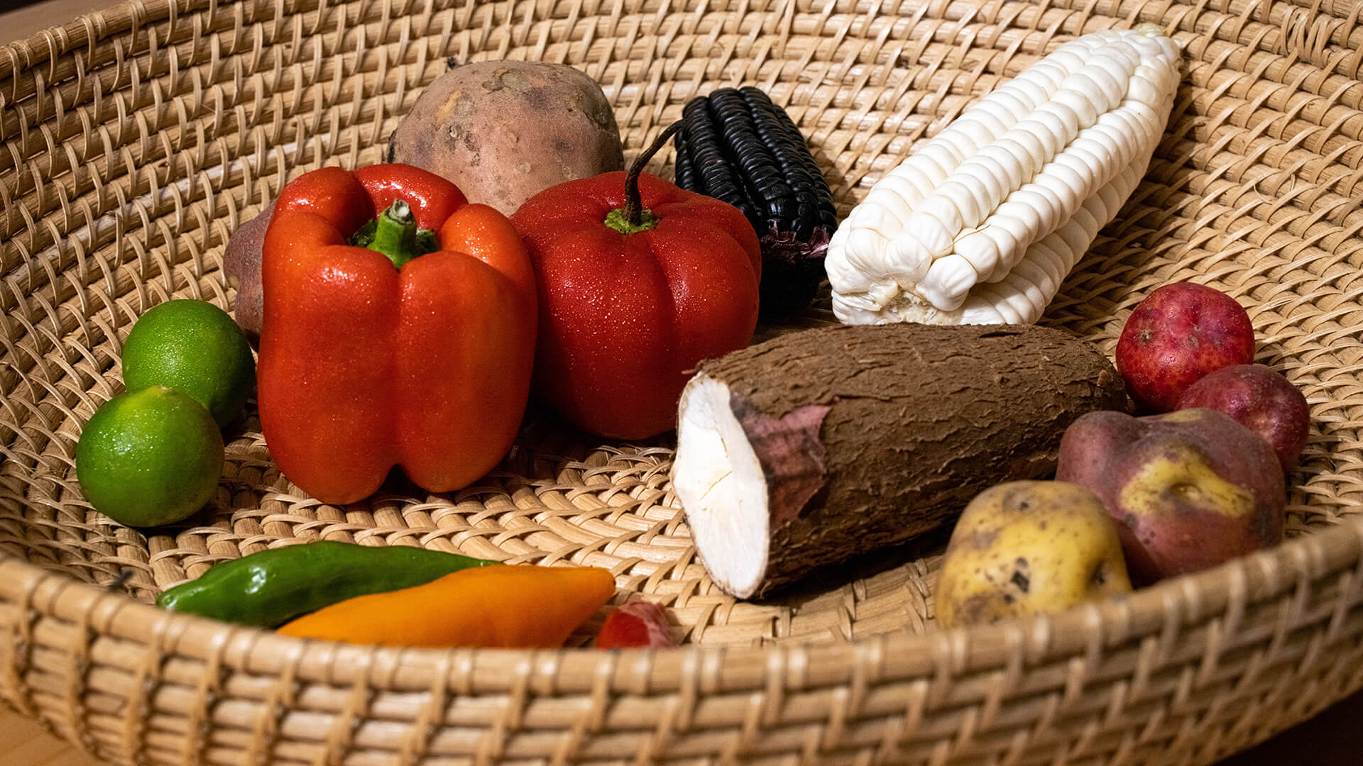 A display of staple peruvian veggies in a beautiful basket - RESPONSible Travel Peru