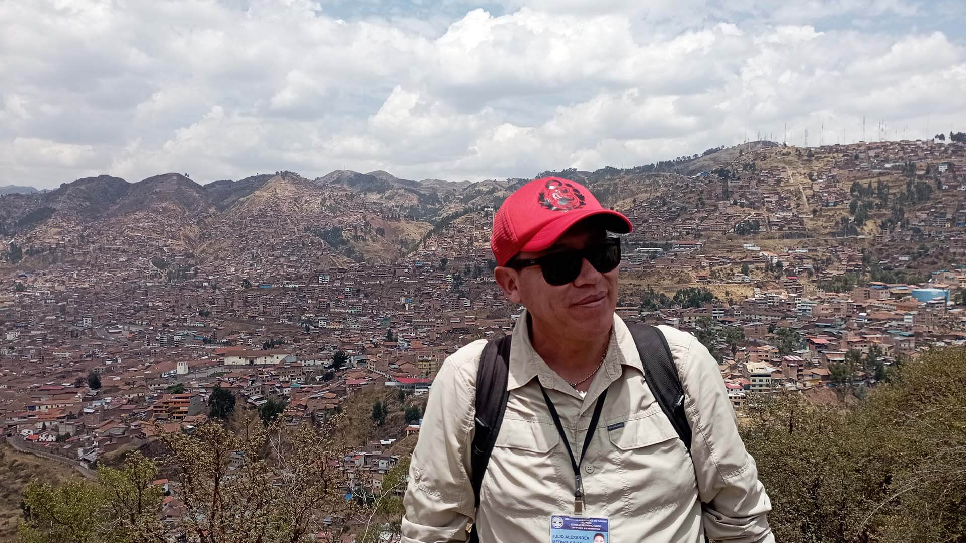 Hills in the city of Cusco with tour guide in front of them - RESPONSible Travel Peru